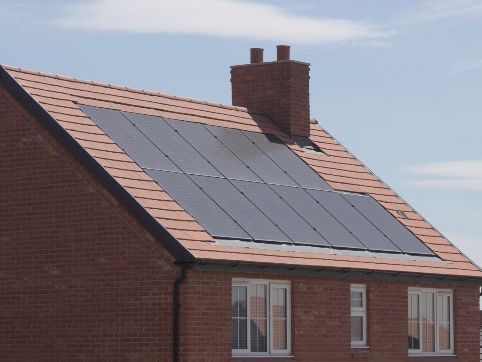Rooftop solar panels on a brick house