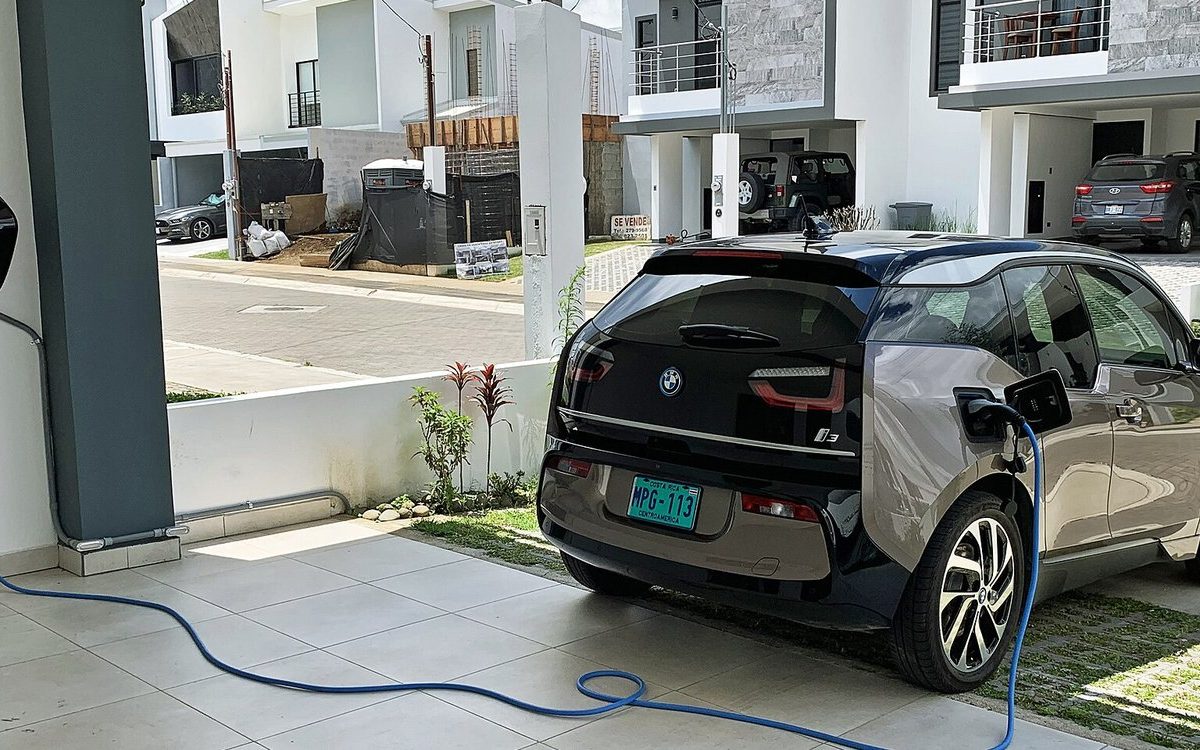 An electric car plugged into a Level 2 charger at home