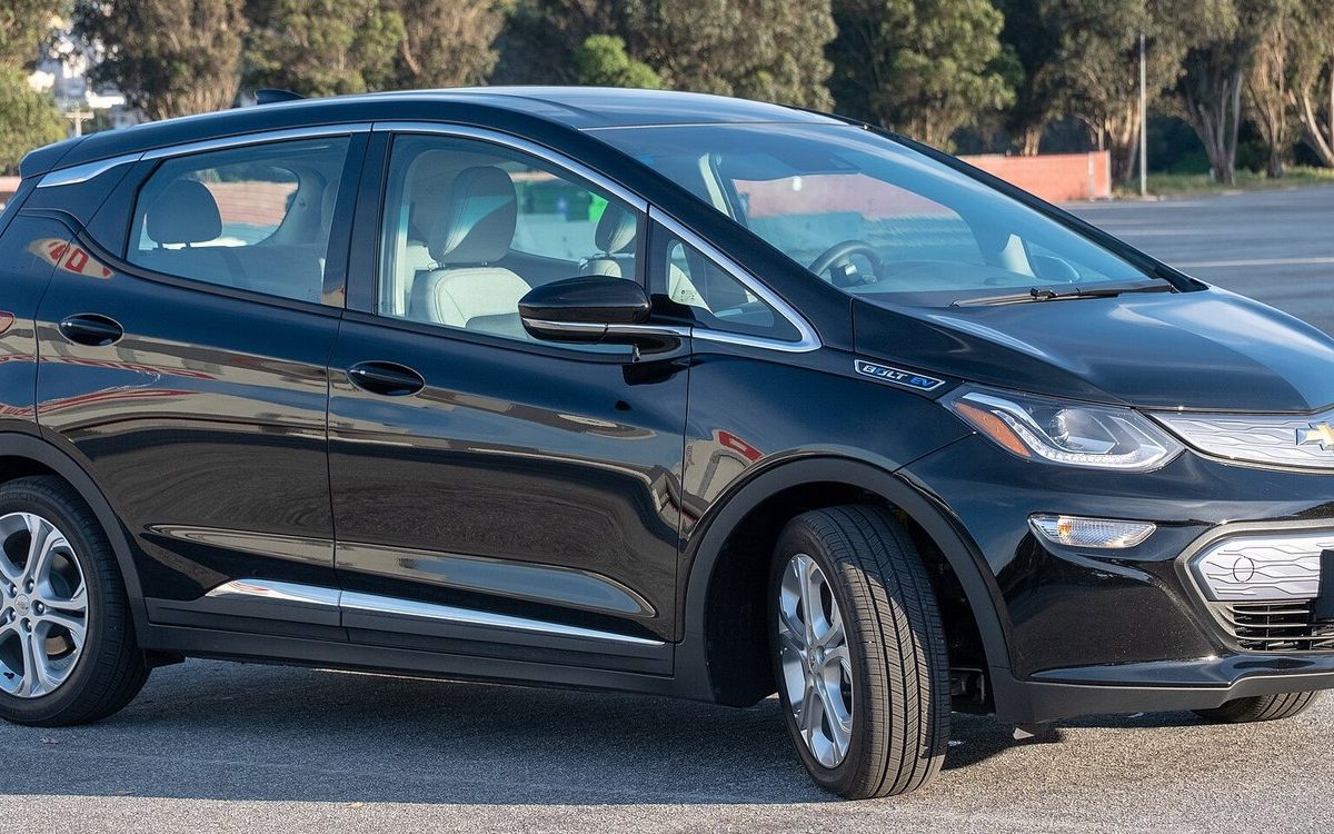 A black Chevrolet Bolt EV, a battery electric hatchback, parked in a lot