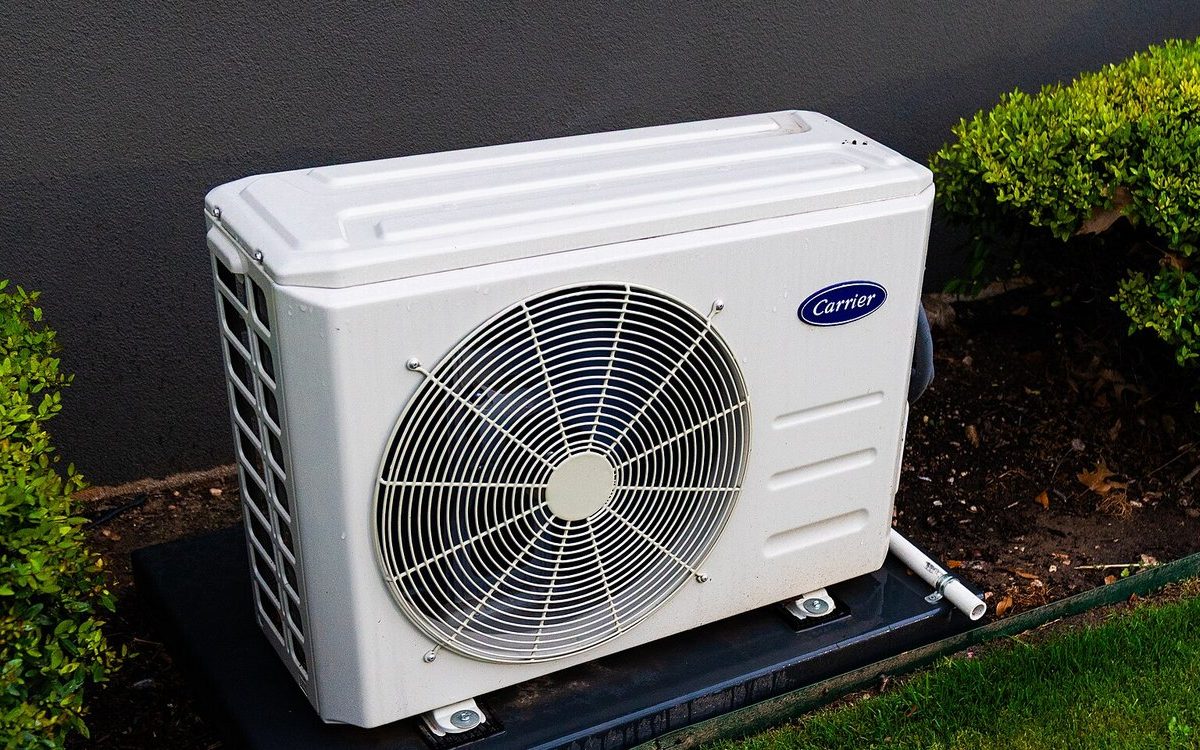 The outdoor unit of a split heat pump system beside a house
